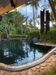 a swimming pool with chairs in a resort at Casa Barbara in Las Terrenas
