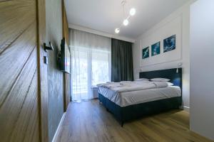 Postel nebo postele na pokoji v ubytování Enklawa Mielno apartamenty przy plaży