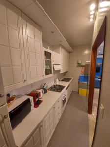 a kitchen with white cabinets and a stove top oven at Le Petit Monde - Eleganza e relax in centro a Abano Terme in Abano Terme