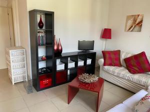 a living room with a couch and a tv at Enea al mare in Cinquale