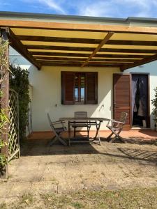 a patio with a table and chairs in front of a house at Enea al mare in Cinquale