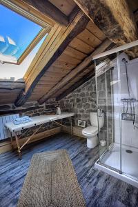 a bathroom with a toilet and a glass shower at La Curva De María in Terán