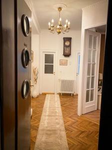 a room with a hallway with a clock on the wall at Apartment Kalina in Novi Sad