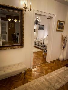 a living room with a mirror on the wall at Apartment Kalina in Novi Sad