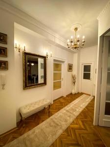 a living room with a bench and a mirror at Apartment Kalina in Novi Sad