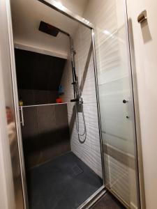 a shower with a glass door in a bathroom at la longère charmante in Céaux +10 photos