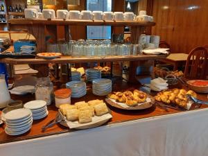 a buffet with plates and pastries on a table at Hotel El Circulo in Mendoza