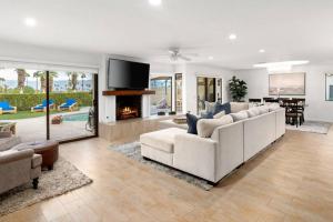a living room with white furniture and a fireplace at Everything You Want! Golf Course, Views, Pool/Spa in Palm Desert