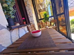 a bowl of fruit sitting on a table on a porch at Studio Jolly Kop Jana 2 in Kopaonik +13 photos