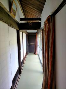 an empty corridor in a room with windows at Neko Neko La Campagne in Tamba +1 photo