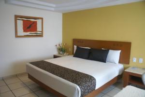 Postel nebo postele na pokoji v ubytování Hotel Arcos Aeropuerto