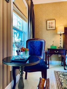 a room with a table and a chair and a window at Darlington House Bed and Breakfast in Niagara on the Lake