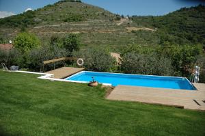 a swimming pool in a yard with a hill in the background at Montericco B&B in Negrar