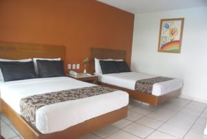 Postel nebo postele na pokoji v ubytování Hotel Arcos Aeropuerto