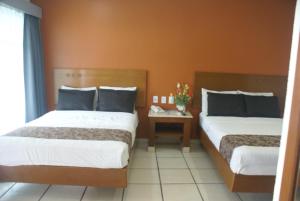Postel nebo postele na pokoji v ubytování Hotel Arcos Aeropuerto