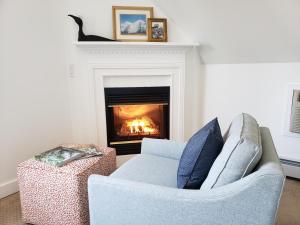 a living room with a couch and a fireplace at Sand Bar Cottage Inn in Bar Harbor