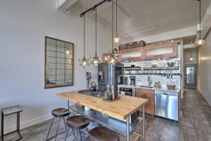 a kitchen with a table and some stools at Chic SLC Downtown Studio Loft Walk to Shops in Salt Lake City