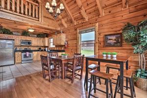 eine Küche mit Holzwänden sowie Holztischen und -stühlen in der Unterkunft Luxe Smoky Mountain Cabin Indoor Pool and Fire Pit! in Sevierville