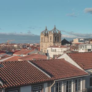 a view of a city with roofs and a church at Burgus Tribute & Design Hotel in Braga