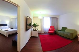 a hotel room with a bed and a red rug at Fiesta Inn Xalapa in Xalapa +41 photos