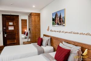 Giường trong phòng chung tại Joy Trip Hotel & Spa Nha Trang