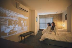 Postel nebo postele na pokoji v ubytování BENJAMIN HOTEL KANAZAWA