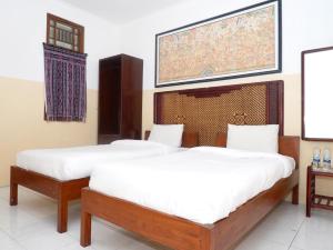 Ein Bett oder Betten in einem Zimmer der Unterkunft Rajasa Hotel