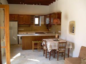 a kitchen with a table and chairs and a table and a kitchen with at Ktima Charitini 2 in Paphos