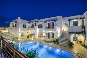 a villa with a swimming pool at night at Summer Dream 1 in Agios Prokopios