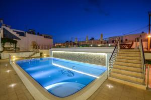 a swimming pool on the roof of a house at night at Summer Dream 1 in Agios Prokopios