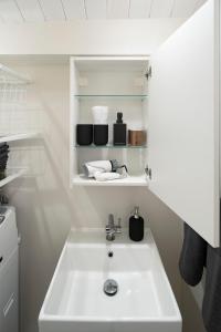 a bathroom with a white sink in a room at Japan Sessions KANZAKI 02 in Osaka