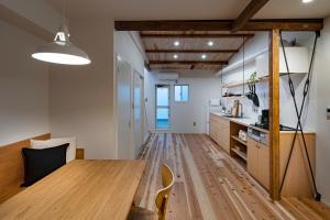 a kitchen and dining room with a wooden table at Japan Sessions KANZAKI 02 in Osaka +15 photos