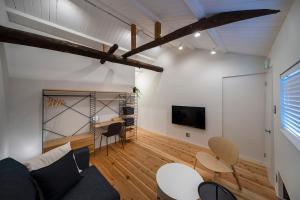 a living room with a couch and a table and chairs at Japan Sessions KANZAKI 02 in Osaka