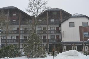 a large apartment building with snow in front of it at Bike & Ski kappe, am Bikepark, Skilift in Winterberg