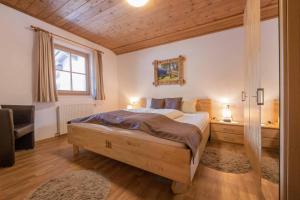 a bedroom with a large bed and a window at Haus Simone in Neustift im Stubaital