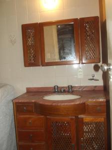 a bathroom with a wooden sink and a mirror at Apartamento Copacabana 243 in Rio de Janeiro