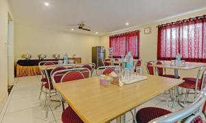 a restaurant with tables and chairs with water bottles on them at Treebo Trend Sai Suites Inn Nagavara in Bangalore
