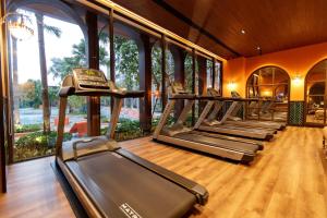 a gym with a row of treadmills and a phone at La Habana in Hua Hin