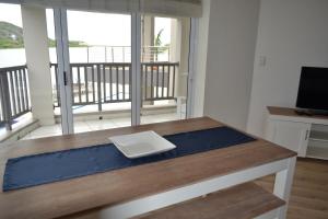 a table with a white plate on top of it at Riviera Hotel Hartenbos in Mossel Bay