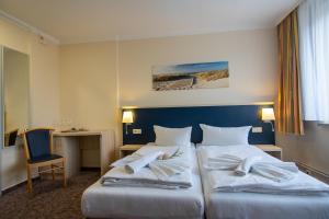 מיטה או מיטות בחדר ב-Hotel Wikinger