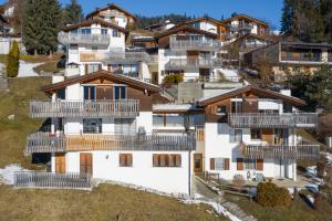 an aerial view of a house with balconies at Casa Darschalè 11 in Laax