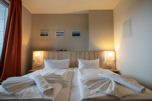Postel nebo postele na pokoji v ubytování Hotel Wikinger