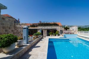 a swimming pool in front of a house at Studio Antica, apartment with a private swimming pool in Močići