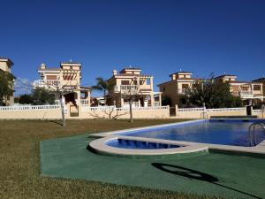 a large house with a swimming pool in front of it at Los Alamos Orangecosta in Peñíscola