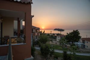 a sunset from the balcony of a house at Alma Hotel in Petra