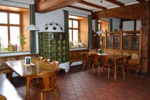 a dining room with wooden tables and chairs at Hotel Sammeth Bräu in Weidenbach