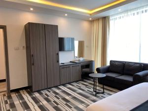 a living room with a couch and a cabinet at ECCO Modern Guest House in Addis Ababa