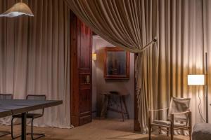 a room with a curtain and a table and chairs at Hotel Can Cera in Palma de Mallorca