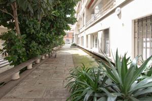 an empty alley with benches and plants in a building at Studio climatisé à 50m des plages in Nice