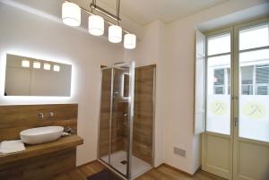 a bathroom with a shower, toilet and sink at Roma 141 in Fossano